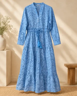 Blue midi dress with allover eyelet cutout pattern, long sleeves, button front, and drawstring waist with tassels.