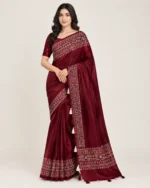 Maroon Ajrakh creap silk saree with printed borders and matching blouse piece.