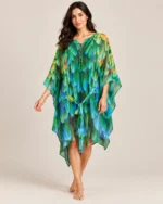 Flowing multicolour printed kaftan with tie-front neckline and wide sleeves hanging on a hanger.